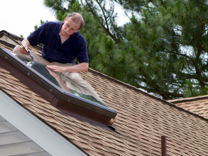 A Columbia roofer inspecting a roof for winter preparation