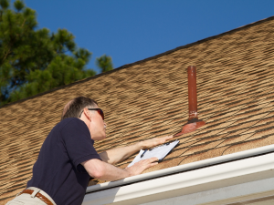 A roof repair expert from American Remodeling Corp inspecting a roof for winter damage in Bowie.