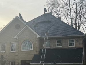 The crew from American Remodeling Corp is repairing roofs as part of their extensive roofing services in Laurel.